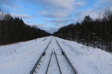 railway in winter. Rails and sleepers - a road for locomotives and electric locomotive covered with...
