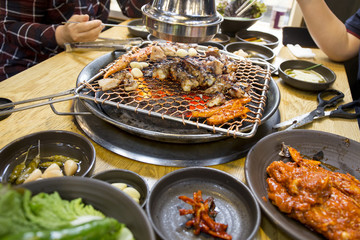 Roast chicken and deodeok over a hot grill in Korean style