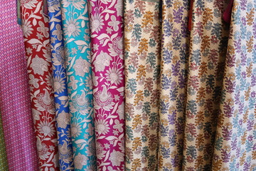 Fabric with oriental ornaments. Multicolored textiles in the bazaar in Dubai.