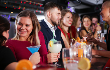 Girl with friends partying in bar