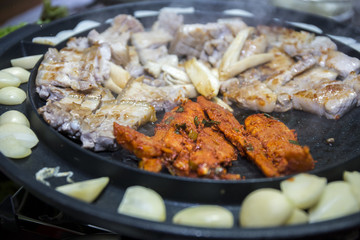 Cooking Korean style barbeque pork with deodeok 