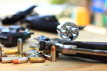 close up group pistol with bullet on table wooden for outdoor sport and hunting,short gun semi...