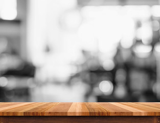 Empty wood table top with blurred black and white cafe background. Mock up for display or montage of product,Business presentation