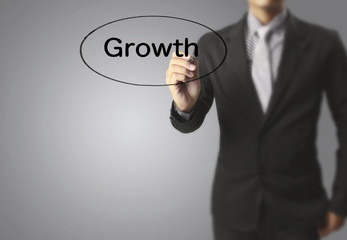 Businessman drawing graphics  growing graph