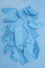 Details and parts of the papercraft scheme for assembling paper or cardboard figures on a blue...