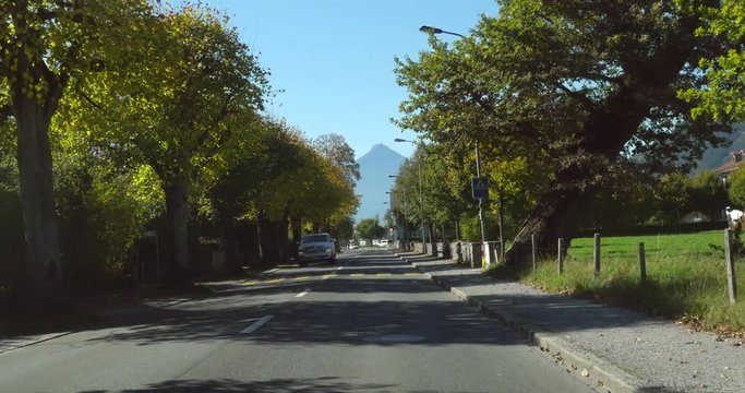 Interlaken, Cinema 4k pov view driving in a city, on a sunny autumn day, in berner oberland, of the swiss alps of Switzerland