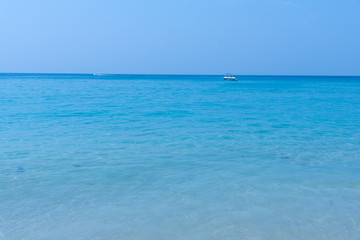 White sand beach and blue sky. Soft wave of blue ocean on sandy beach. Background. concept for summer season.