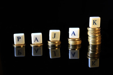 Stack of Golden Rupiah, Indonesia Coin, Illustration for Raising Pajak (Tax in Indonesia Language) article, report, journal or other related, at Black Background with reflection at the bottom
