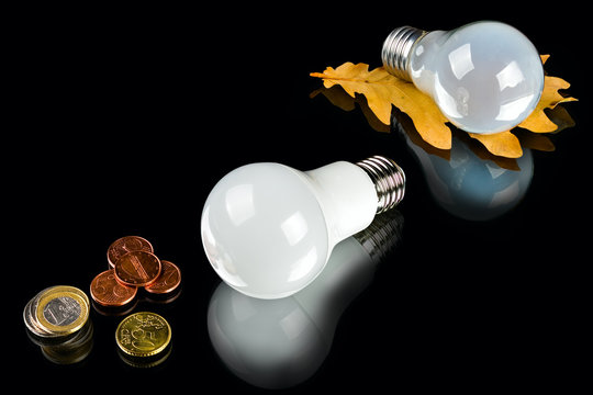 white innovation energy-saving LED bulb, glow-lamp and coins