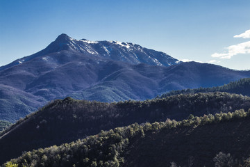 Rocky mountain peak on a blue sunny sky