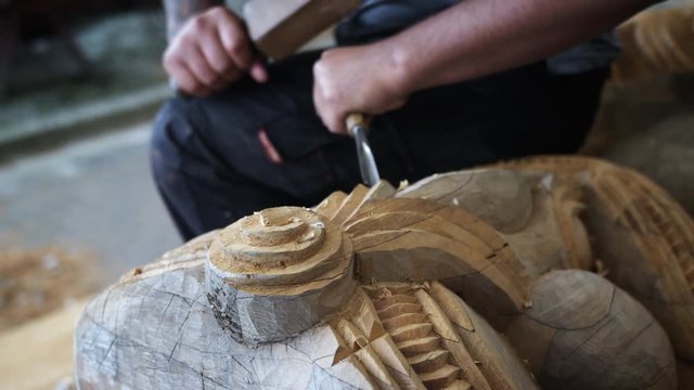 Close up of carving a wooden Maori sculpture.