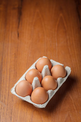 Eggs in cardboard on table