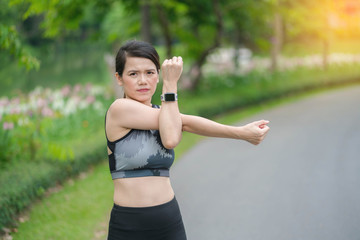 Asia woman warming up before a workout standing facing the early morning