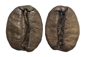 Naklejka premium Macro photo of two roasted coffee beans. Furrow in the middle. On a white background. Photo for the site about food, drinks, health, business.