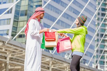 Happy Arabic men with city shopping hand holding paper bags