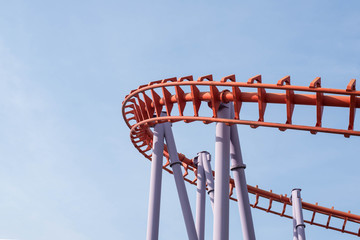Roller coaster on blue sky background.