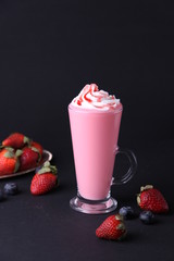 Milk shake with strawberry / Strawberry Cocktail with whipped cream and syrup on a dark background