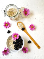 oatmeal for Breakfast with BlackBerry and flowers on white background