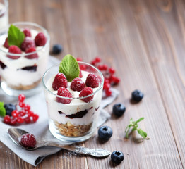 Healthy breakfast - yogurt with fresh  berries and muesli served