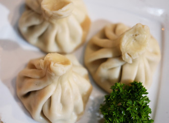 Georgian dumplings Khinkali with meat, greens and tomato spicy s