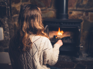 Young woman poking a fire