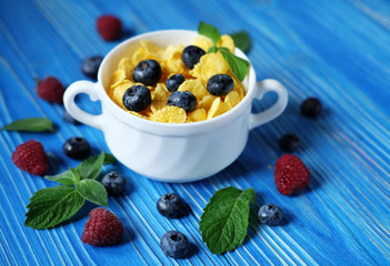 Healthy eating, food  and diet concept - Cornflakes with berries