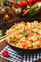 Fried rice with chicken. Prepared and served in a wok.