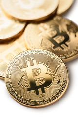Macro shot of crypto currency gold Bitcoin coins. Isolated on white background