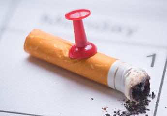 Cigarette butt on calendar. Time to quit smoking concept