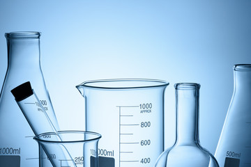 Laboratory glassware set with reflections on blue background