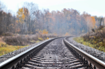 Fototapeta na wymiar Soft blur photos taken on the soft lens. Railroad in autumn stretches into the distance.