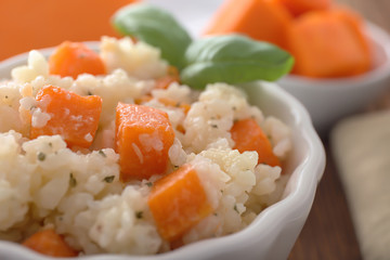 Bowl with delicious pumpkin risotto, closeup