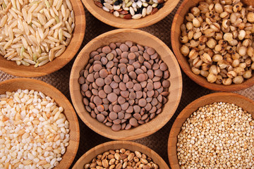 Variety of rice and grains in bowls close up with top view