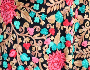 Fabric with oriental ornaments. Multicolored textiles in the bazaar in Dubai.