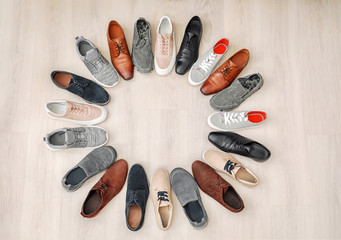 Frame made of different male shoes on wooden background