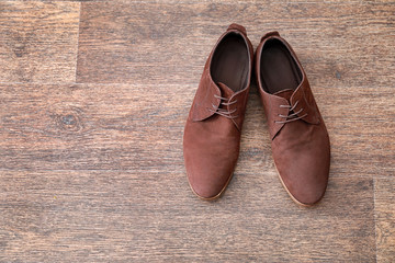 Elegant male shoes on wooden floor