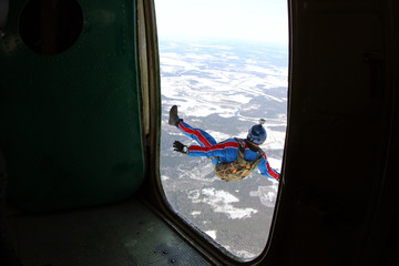 Skydiver is jumping out of aplane.