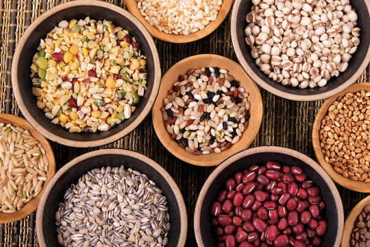 Variety of rice and grains in bowls close up with top view