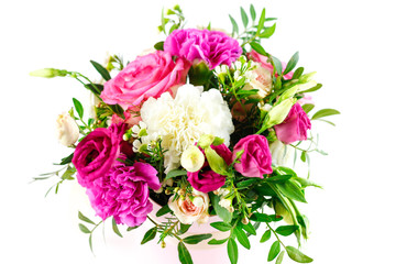 Composition of flowers in a pink hatbox. Tied with wide white ribbon and bow