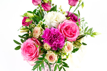 Composition of flowers in a pink hatbox. Tied with wide white ribbon and bow
