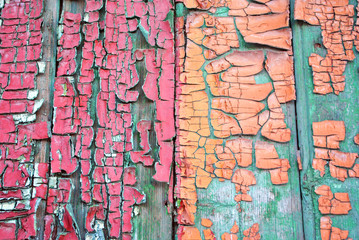 Wooden old surface painted with  turquoise, red and sepia shabby paint, horizontal grunge background texture