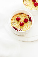 Cherry crumble in a white form on a white background. Food concept