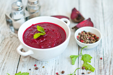 summer cream soup made from beets and carrots with greens and spices with a detoxification top view. Diet, clean food, weight loss, the concept of vegetarian food.