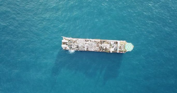 Aerial view of an offshore oil installation and supply ship