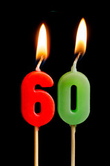 Burning candles in the form of sixty figures (numbers, dates) for cake isolated on black background. The concept of celebrating a birthday, anniversary, important date, holiday, table setting
