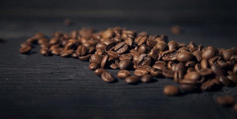 coffee beans on a black old  wooden bg blur effect