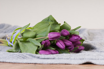 Obraz na płótnie Canvas Tulips bouquet on grey textile