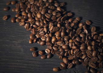 coffee beans on a black old  wooden bg