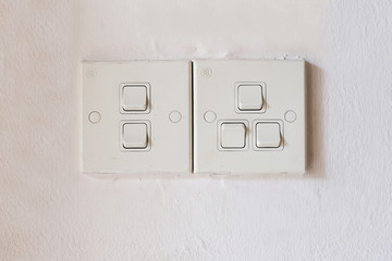 White wall socket on wall, unplug or plugged in concept.Vertical power electric plug outlet.