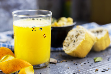 french homemade orange juice with gratin of potato and cheese and meat with sliced of bread